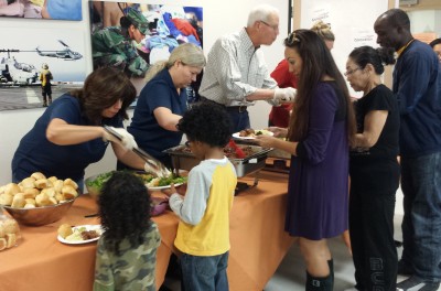 Higgs Fletcher & Mack staff serve dinner to military families at the USO. 